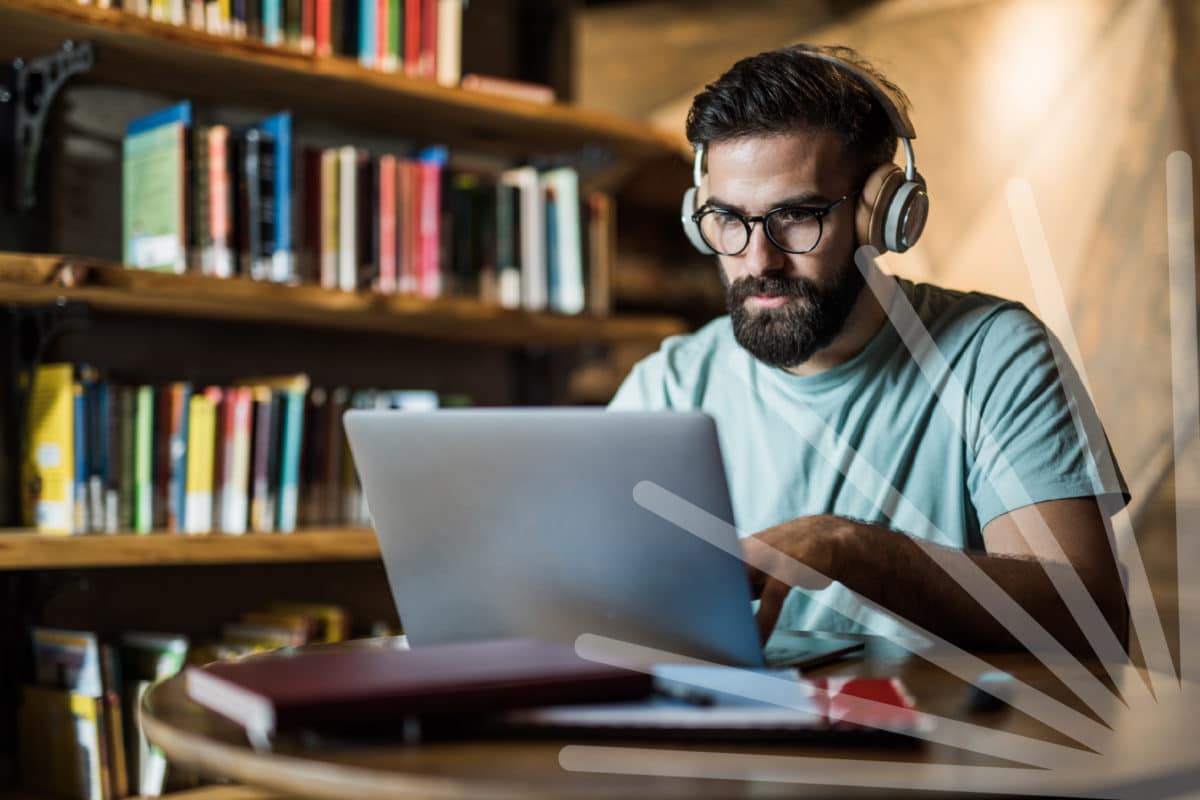 Man using laptop with headphones on