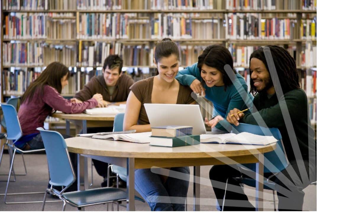 Group of three people sat in a library