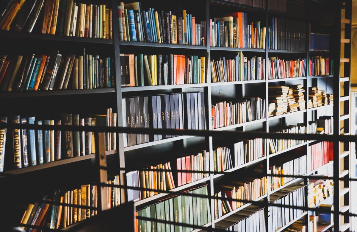 Books stacked on shelf in a library