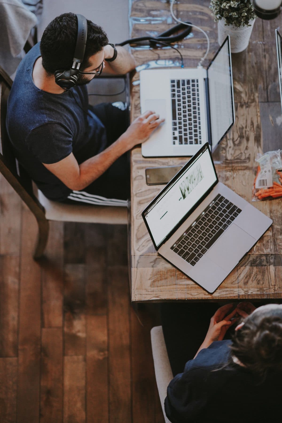 Person using laptop with another laptop open