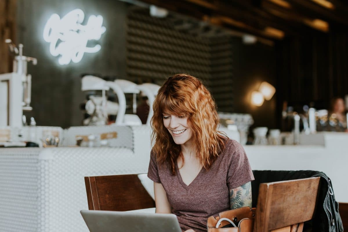 woman smiling using computer