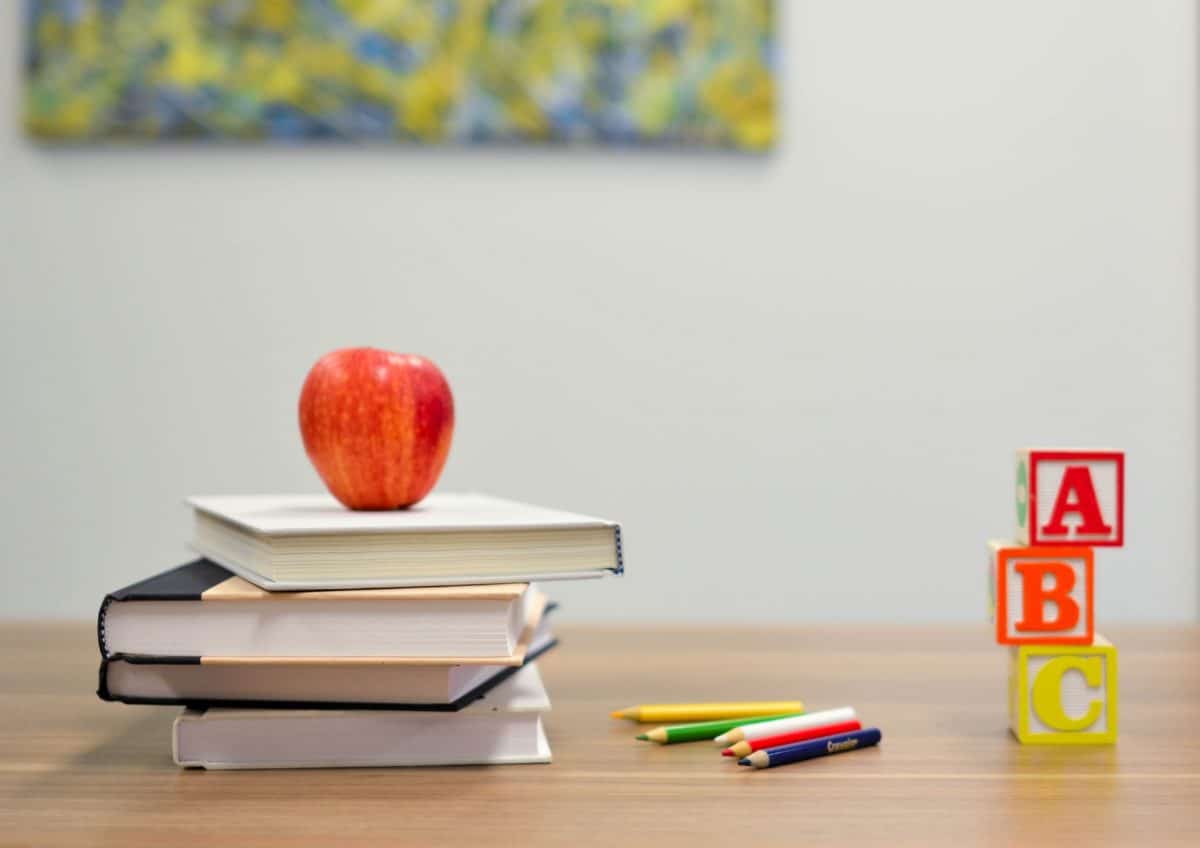 Apple stacked on books