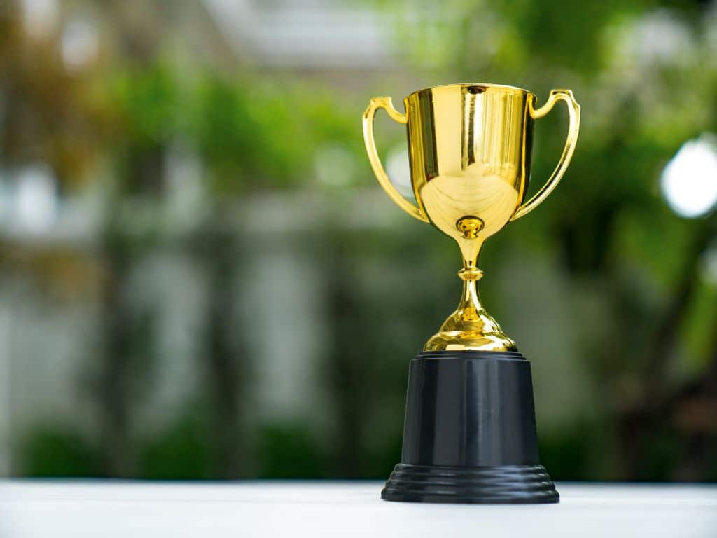 Image of a gold trophy set on a table with a blurred background