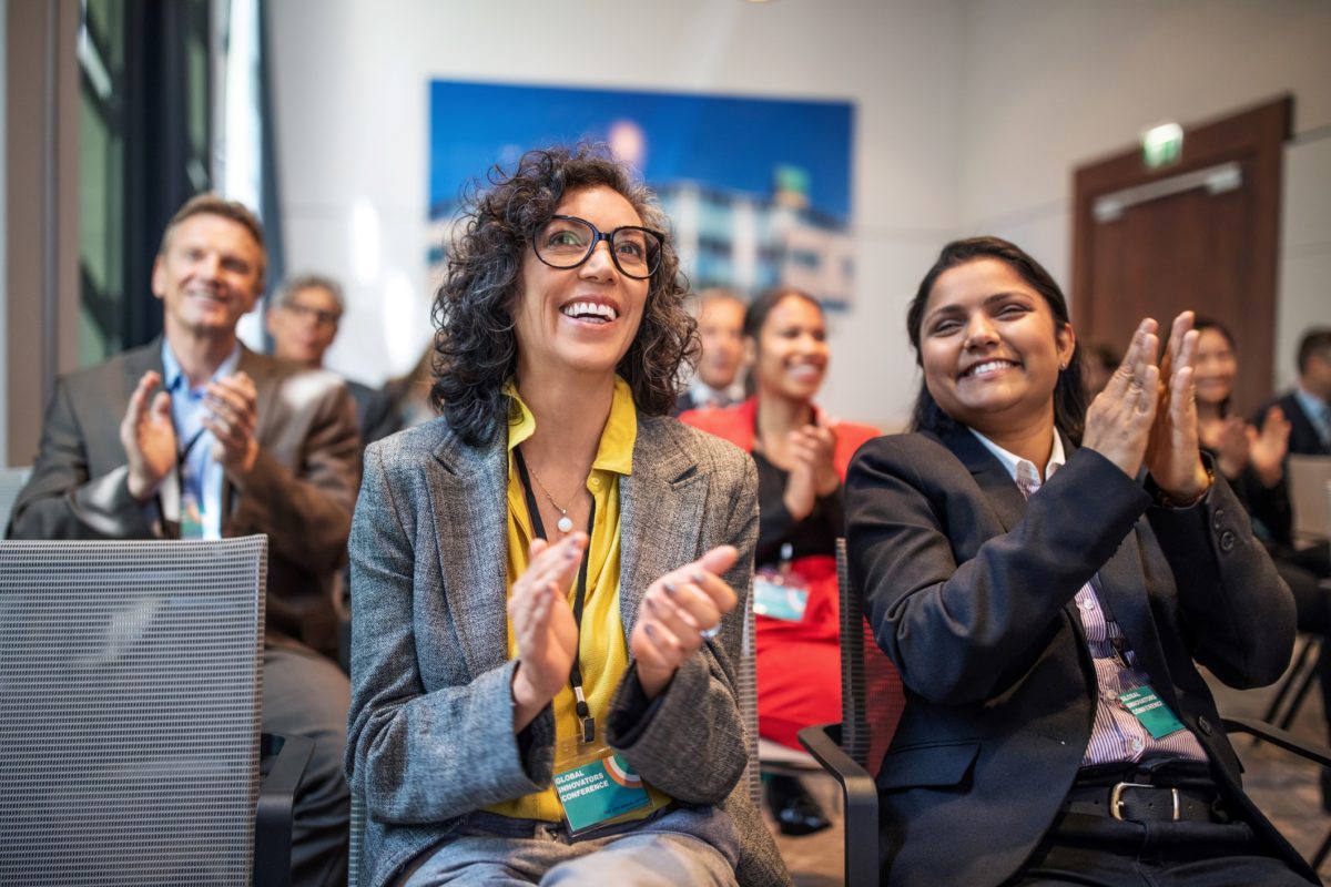 Access Lab 2024. Multi-ethnic people clapping at an event.