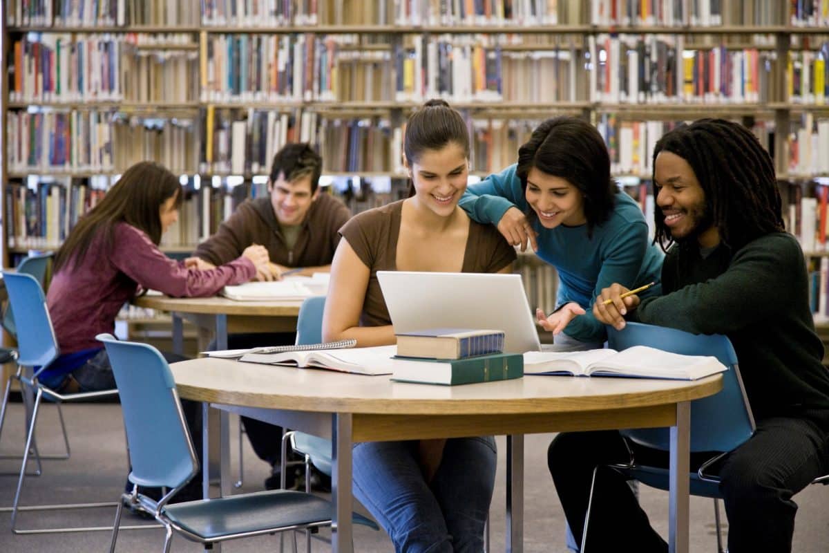 Multi-ethnic college students studying at library