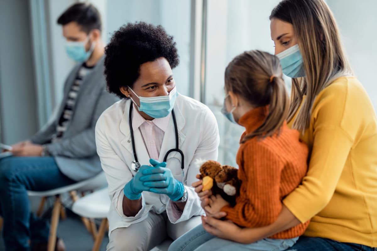 Pediatrics. Female doctor with mother and child.