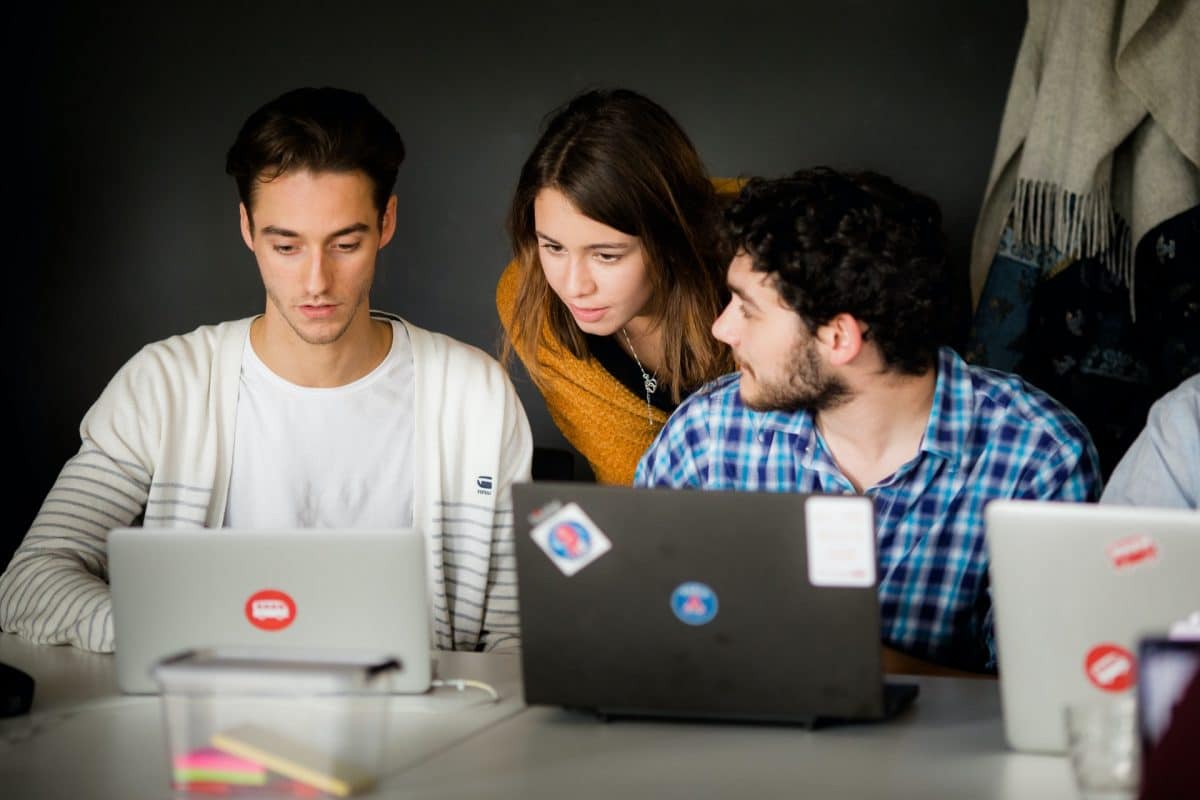 Three students looking at laptops. IOP Publishing pilot Wayfinder integration with the SeamlessAccess service.