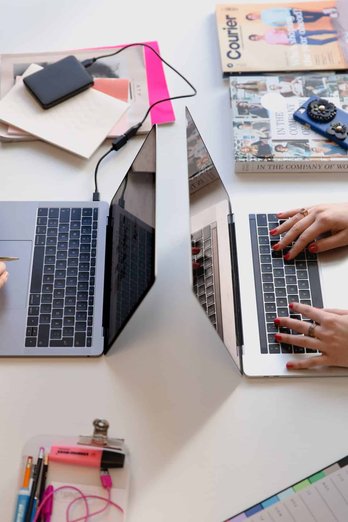 Two laptops back to back on a desk