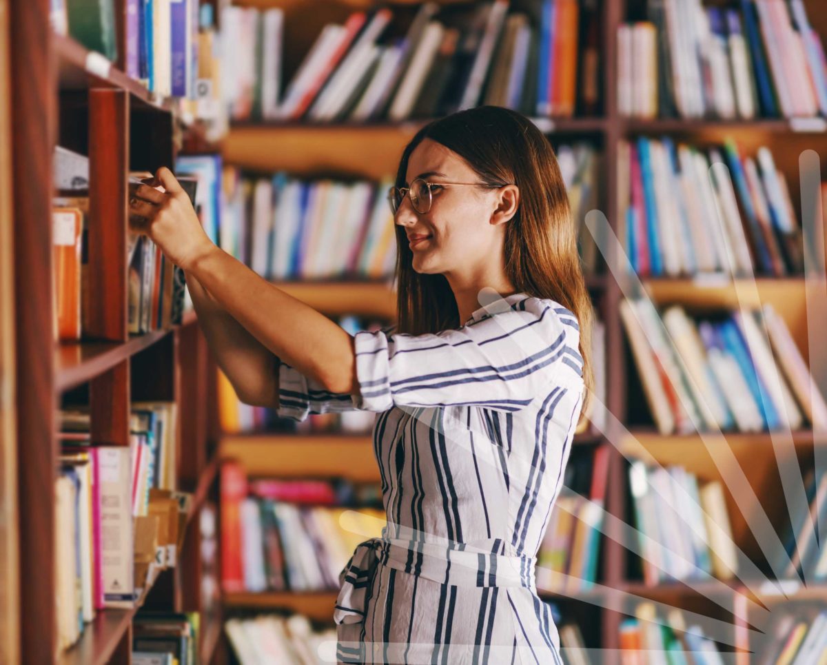 Lady choosing a book from the library