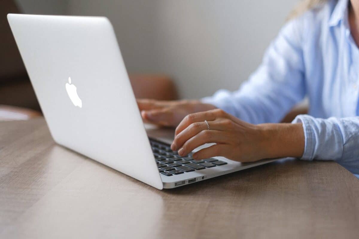 hands on laptop keyboard