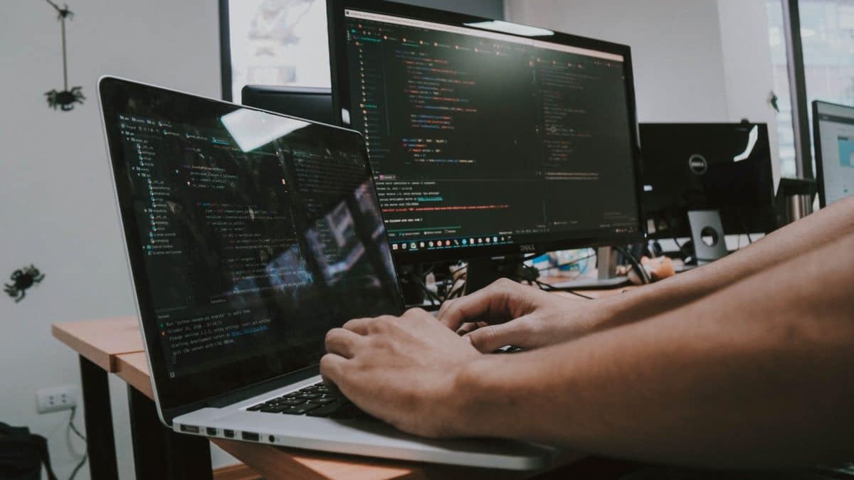 Laptop and monitor used by a person to research cyber security